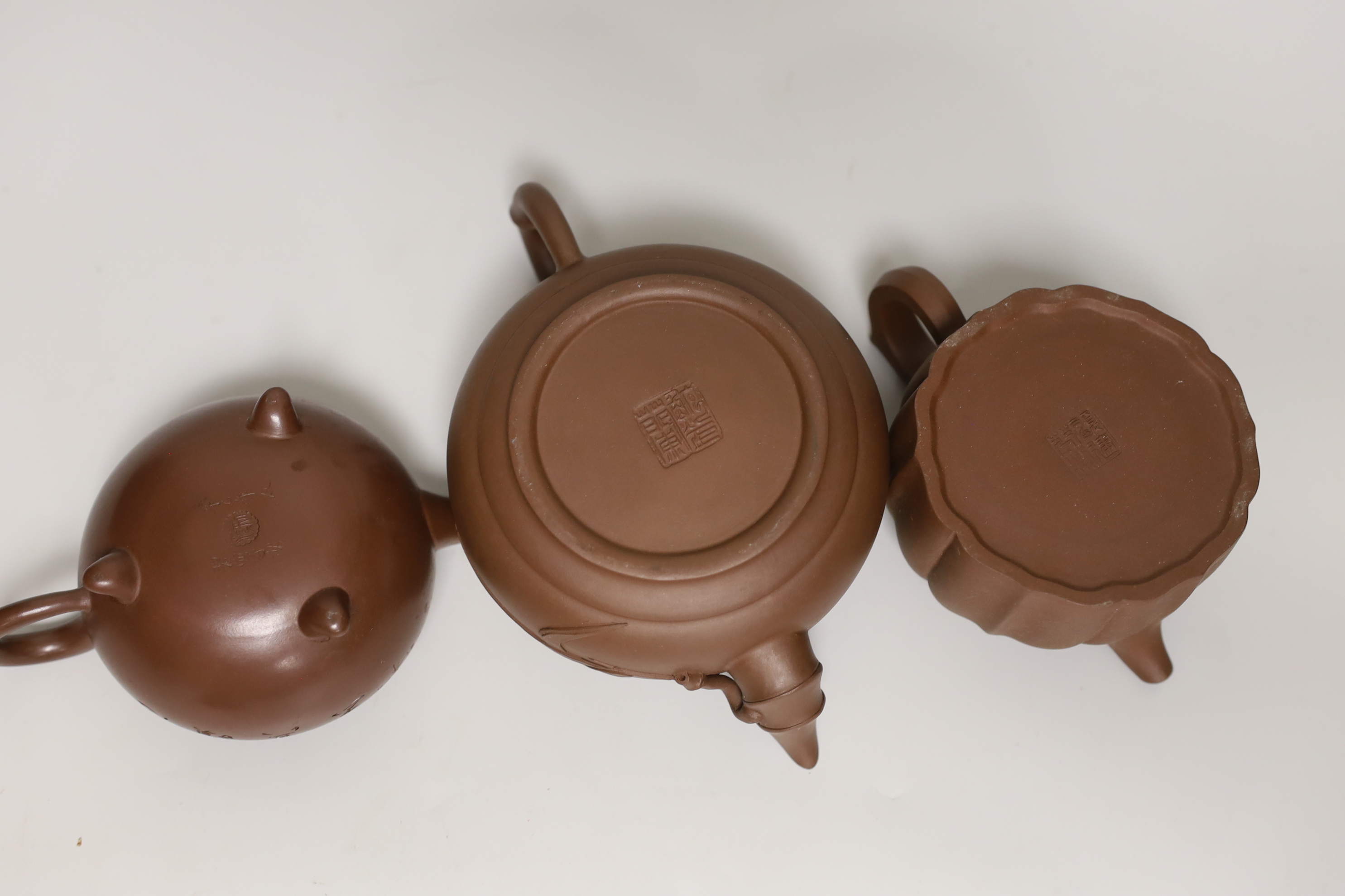 Three Chinese Yixing dark brown zisha clay teapots, one with marbled clay band largest 12cm diam.